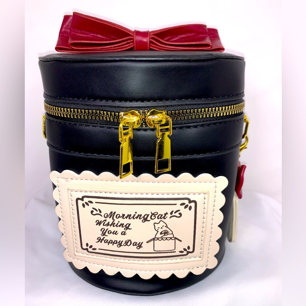 Black trunk style crossbody handbag.